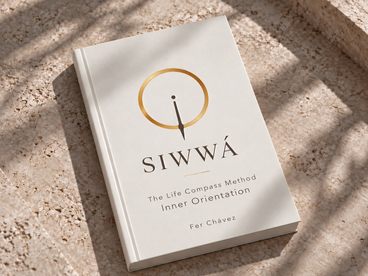 SIWWÁ book mockup resting on warm stone in soft natural light.